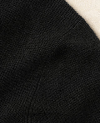 Black knit cardigan sleeve with ribbed cuff and smooth knit texture