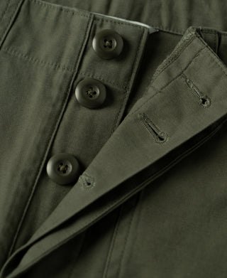Olive pants button fly area with belt loops and bar-tack stitching