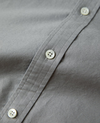 Gray shirt placket with white buttons and seam detail