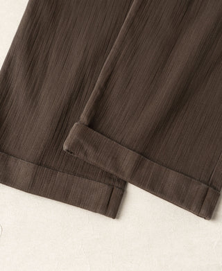 Brown trouser hem with cuffed bottom and visible lining