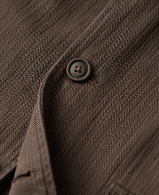 Brown herringbone blazer button detail on the front placket