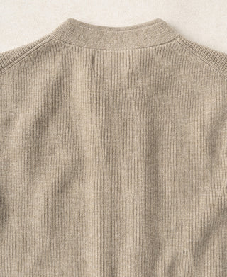 Ecru knit cardigan back with ribbed crew yoke and shoulder seam detail.