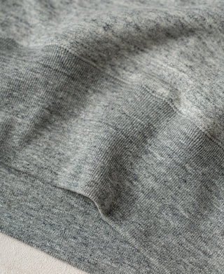 Heather gray sweatshirt hem and ribbed cuff seam close-up