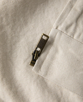 Natural twill jacket zipper pull with metal track and small branding tag