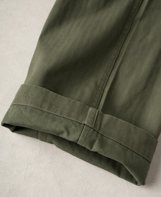 Olive deck pants with stitched hem cuff at the leg opening.