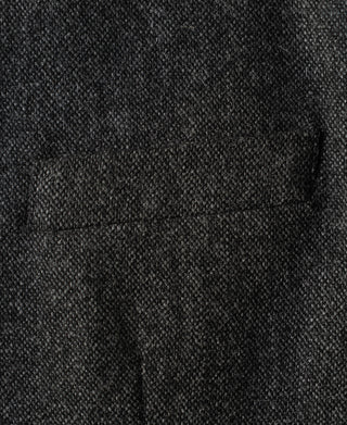 Gray wool suit jacket chest pocket detail with textured weave