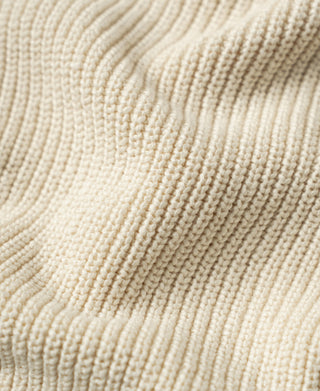 Close-up of the cardigan's raised fisherman-rib cotton knit texture