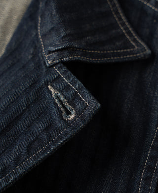 Indigo denim jacket detail with side flap pocket and contrast stitching