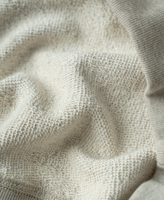 Light heather knit interior texture close-up on Apricot Gray sweatshirt