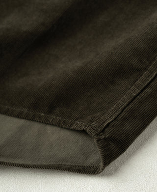 Corduroy shirt hem with dark green fabric texture and stitched edge