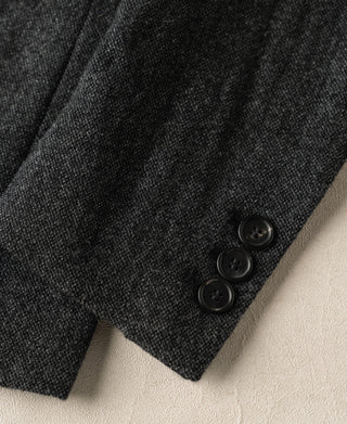 Gray wool suit jacket sleeve cuff with three dark buttons