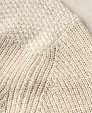 Cotton sweater close-up of seed-stitch shoulder and ribbed body knit