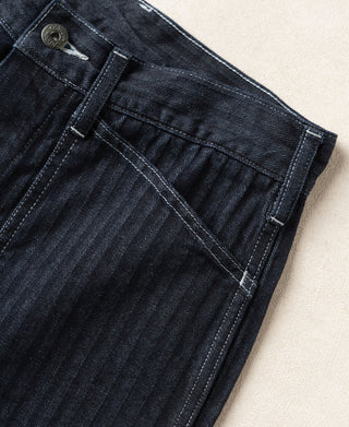 Indigo denim fatigue pants side close-up of belt loops and stitched front pocket