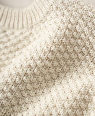 Cotton sweater close-up of chunky seed-stitch shoulder texture