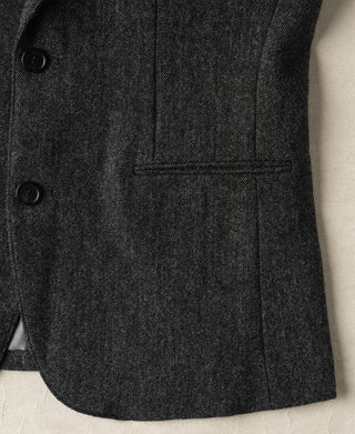 Gray wool suit jacket front pocket and button placket close-up