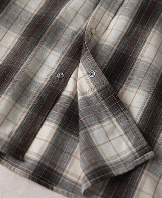 Beige and dark plaid western shirt with chest pocket and snap-button detailing