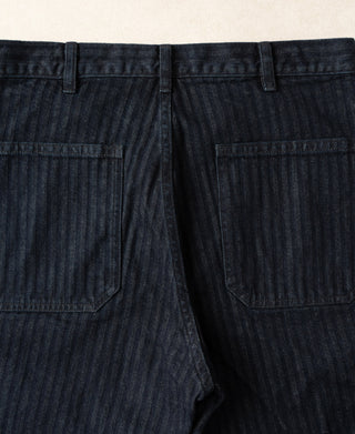 Indigo herringbone denim work pants with front button fly and two front patch pockets