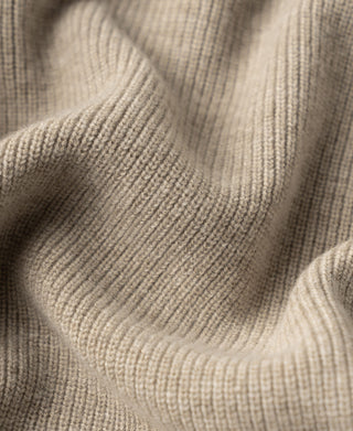 Ecru knit cardigan fabric texture close-up with fine ribbed stitch pattern.
