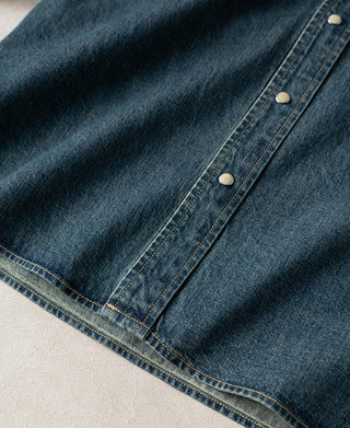 Washed denim western shirt hem with long sleeve cuff and rows of contrast stitching