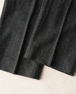 Hem area of gray wool trousers with stitched cuff edge