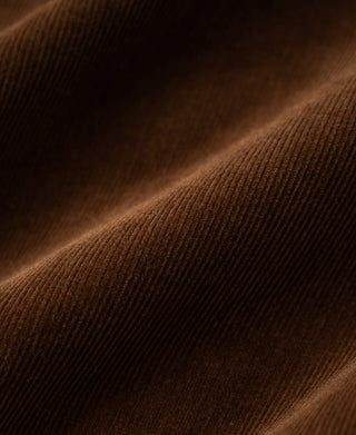 Brown corduroy fabric texture with fine ridges and soft nap