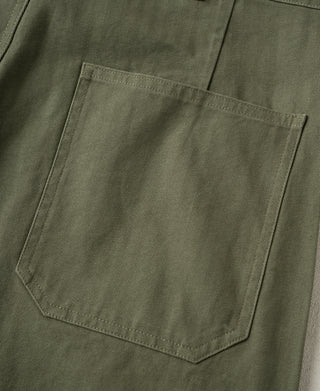 Olive deck pants with a single patch pocket on the front leg.