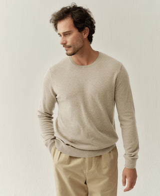 Close-up view of an apricot merino wool sweater showing the fine knit texture and comfortable fit