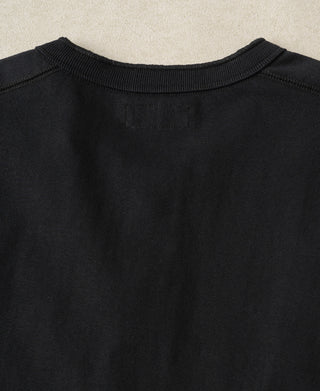 Back view of a black loopwheel cotton Henley shirt showcasing its clean vintage silhouette.