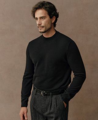 Detail view of a black merino wool mock neck sweater featuring a classic high neckline and smooth knit finish