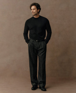 Man wearing a black merino wool mock neck sweater with a refined minimalist style and tailored silhouette