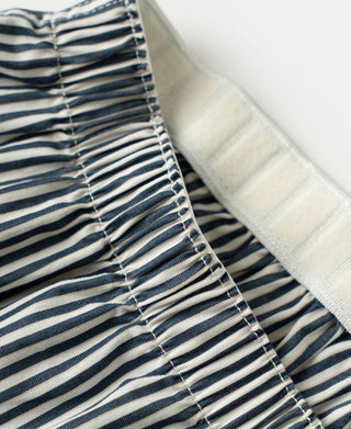 Close up view of the elastic waistband and striped cotton fabric