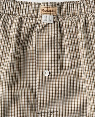 Close up view of the button and fine striped cotton fabric texture