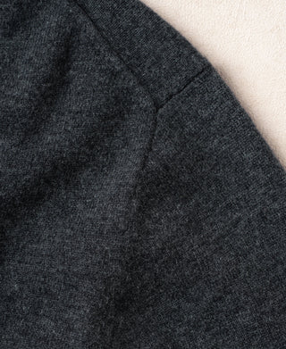 Heather gray sweater sleeve seam detail with subtle textured knit pattern
