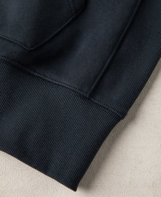 Detailed view of the ribbed hem and lower body construction