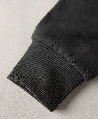 Close up of the ribbed cuff on the dark gray heavyweight hoodie