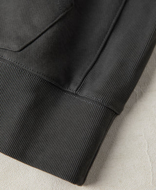 Detailed view of the ribbed hem and lower body construction