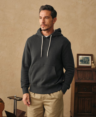 Man wearing the dark gray heavyweight cotton hoodie with khaki pants