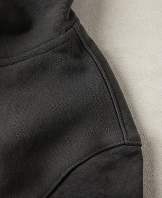 Close up of the shoulder seam and heavyweight cotton fabric in dark gray