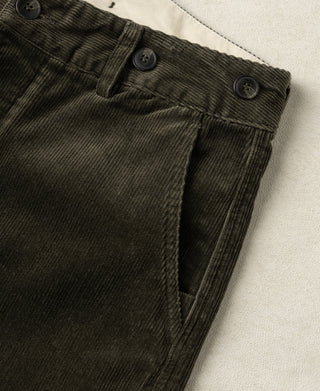 Dark green corduroy trousers front with belt loops and side pocket opening