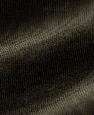 Dark green corduroy fabric with fine vertical wales