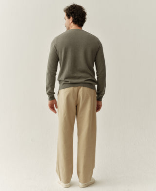 Back view of a grayish green merino wool sweater showing the simple design and comfortable fit