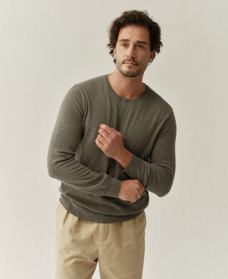 Close-up view of a grayish green merino wool sweater showing the soft knit texture and refined craftsmanship
