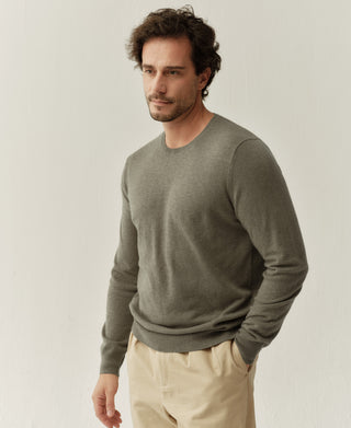 Side view of a grayish green merino wool crewneck sweater highlighting the relaxed fit and smooth knit finish