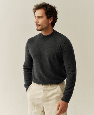 Close-up view of a heather gray merino wool mock neck sweater featuring a soft knit texture and elevated collar design