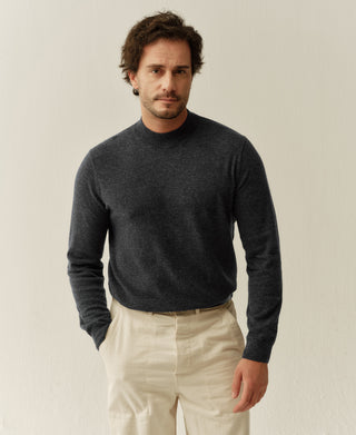 Front detail of a heather gray merino wool mock neck sweater showing the clean silhouette and premium wool finish