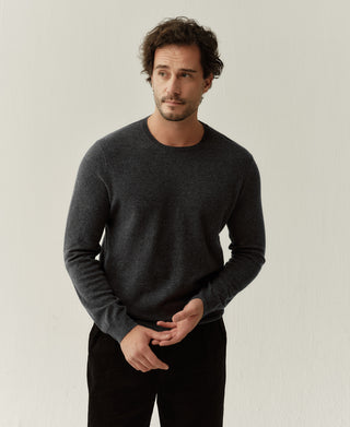 Close-up view of a heather gray merino wool sweater highlighting the soft knit texture and premium wool finish