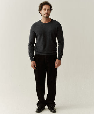 Man wearing a heather gray merino wool crewneck sweater with a clean and timeless casual style