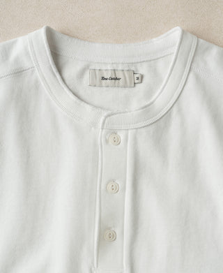 Close-up showing the natural drape, cotton texture, and durable construction of a loopwheel Henley shirt.