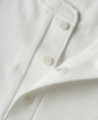 Close-up view of the three-button Henley placket and textured cotton fabric on a navy loopwheel shirt.