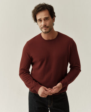 Close-up view of a jasper red merino wool sweater showing the soft knit texture and refined details